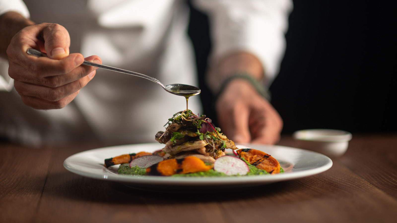 Chef plating a fine dining dish
